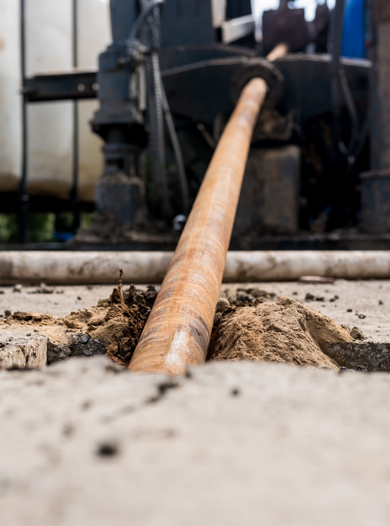 Low angle view of Horizontal directional drilling technology. Drilling machine work process. Trenchless laying of communications, pipes and water pipes. Close up
